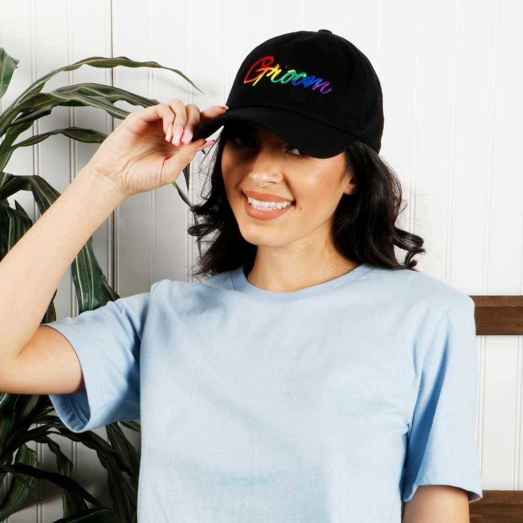 Model wearing black dad hat with groom embroidered in rainbow - DSY Lifestyle