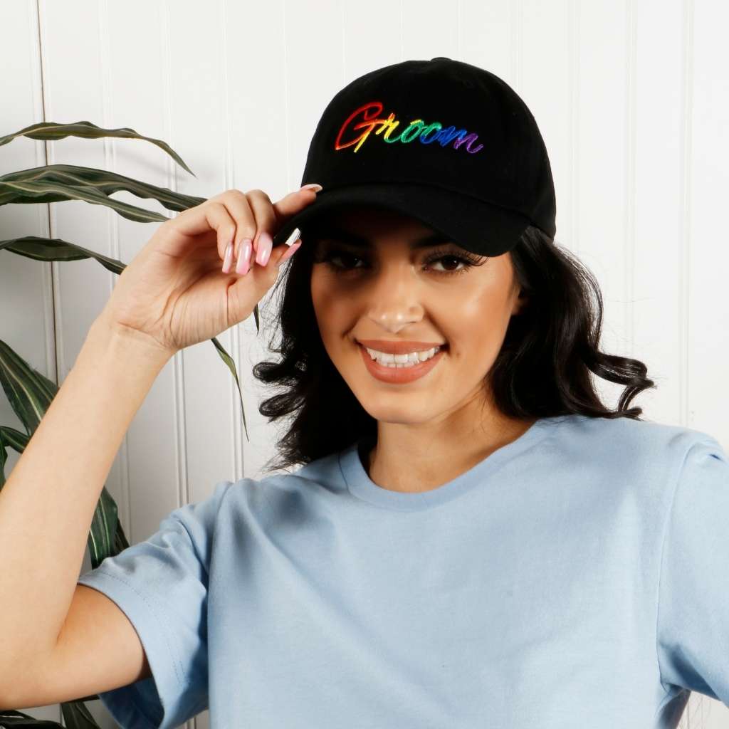 Model wearing black dad hat with groom embroidered in rainbow - DSY Lifestyle