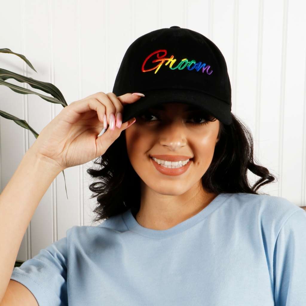 Model wearing black dad hat with groom embroidered in rainbow - DSY Lifestyle