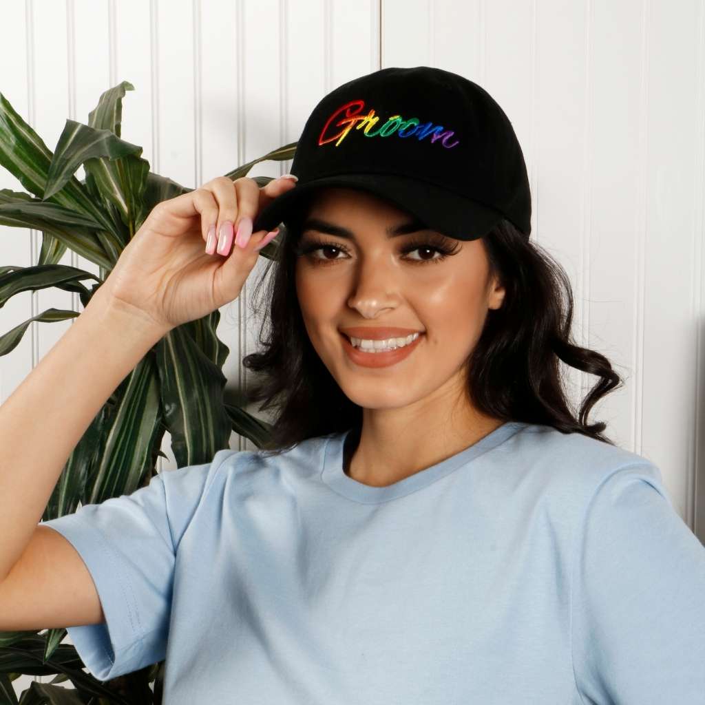 Model wearing black dad hat with groom embroidered in rainbow - DSY Lifestyle
